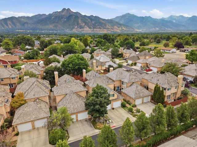 Residential community featuring uniform rooflines and a mountainous backdrop