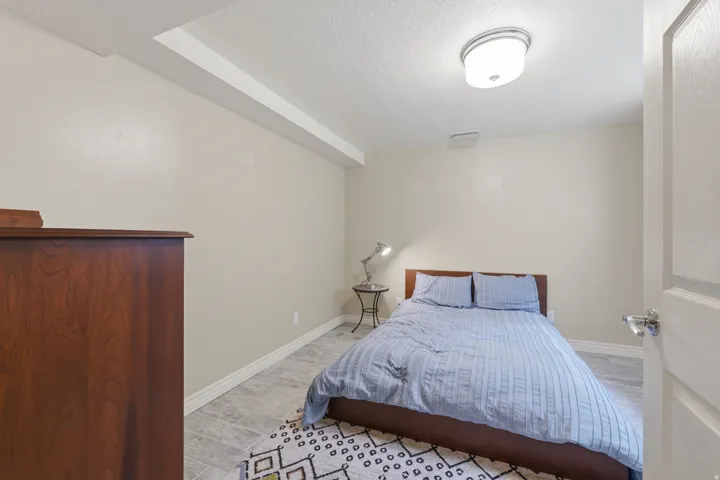 Room featuring light-toned walls and wood-finish flooring