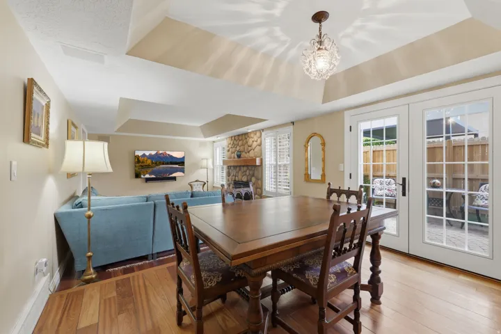 Tray ceiling with a decorative chandelier and recessed lighting