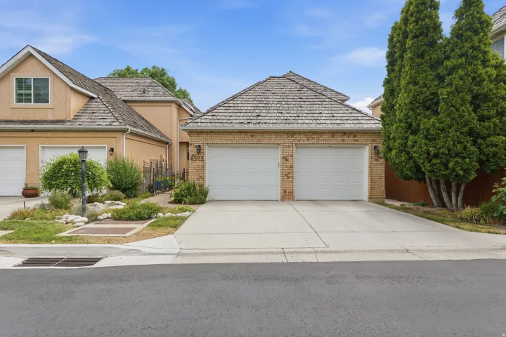 Two-car garage with brick facade and wood-shingle roof