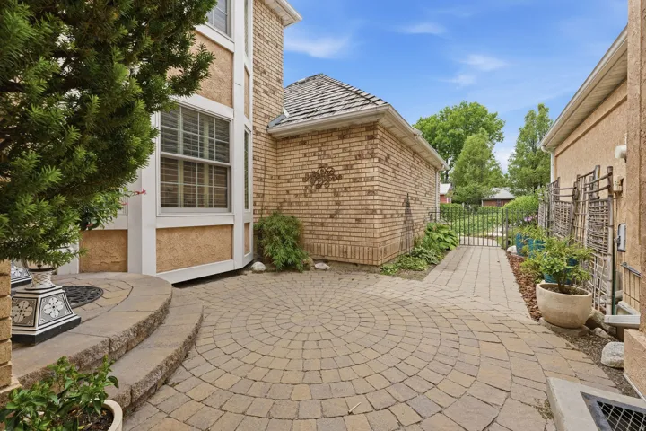 Paver patio with a circular pattern and stone steps