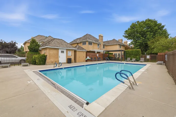 Outdoor swimming pool with integrated steps, surrounded by a concrete deck