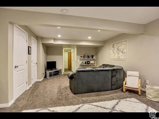Spacious room featuring neutral carpeting and recessed lighting