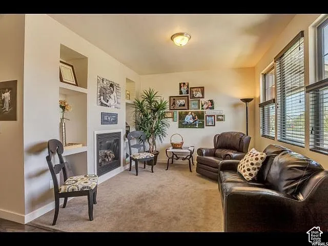 Living area featuring a built-in fireplace with a white surround and recessed shelving