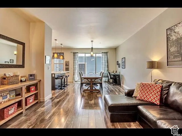 Open-concept living space featuring wood-finish flooring, recessed lighting, and a neutral color palette