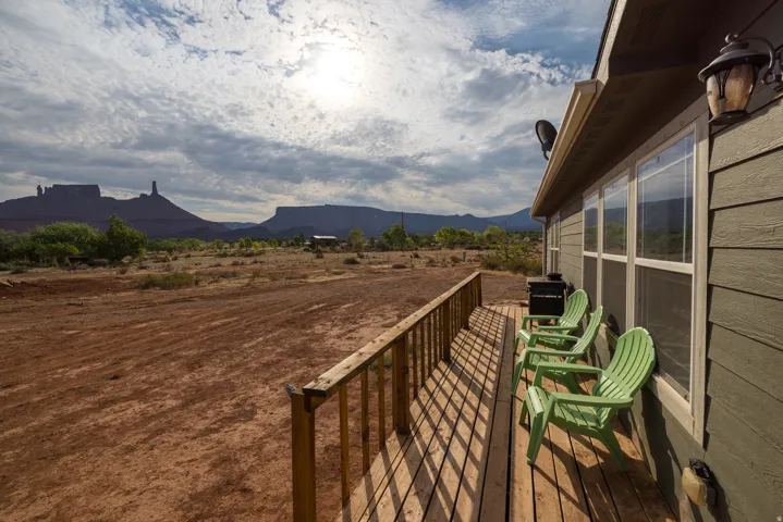 Expansive exterior deck featuring natural wood flooring and a complementary wood railing
