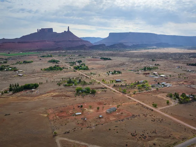 Expansive desert landscape featuring red rock formations