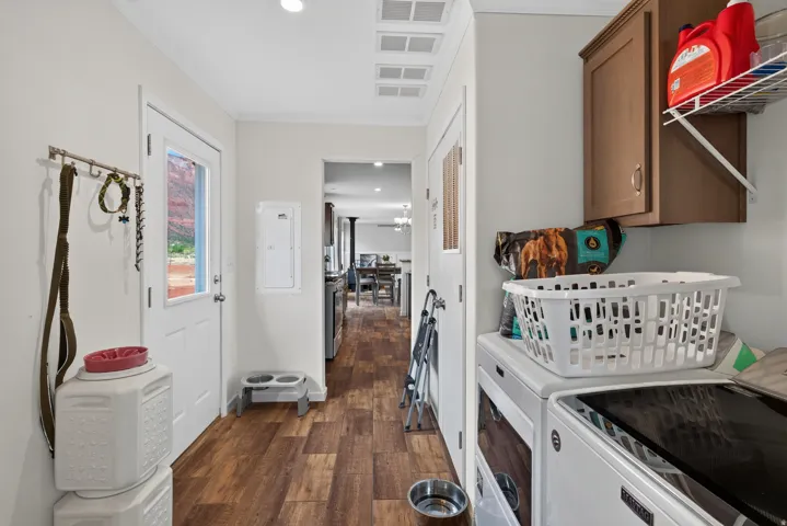 Functional utility space featuring wood-finish flooring and recessed lighting