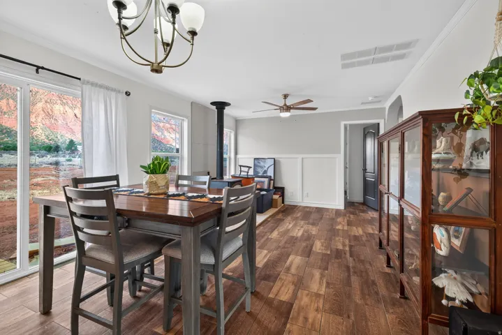Spacious interior with wood-finish flooring, white trim, and a built-in wood-burning stove