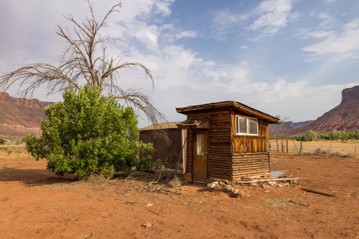 Rustic wood-sided structure with a white-framed window