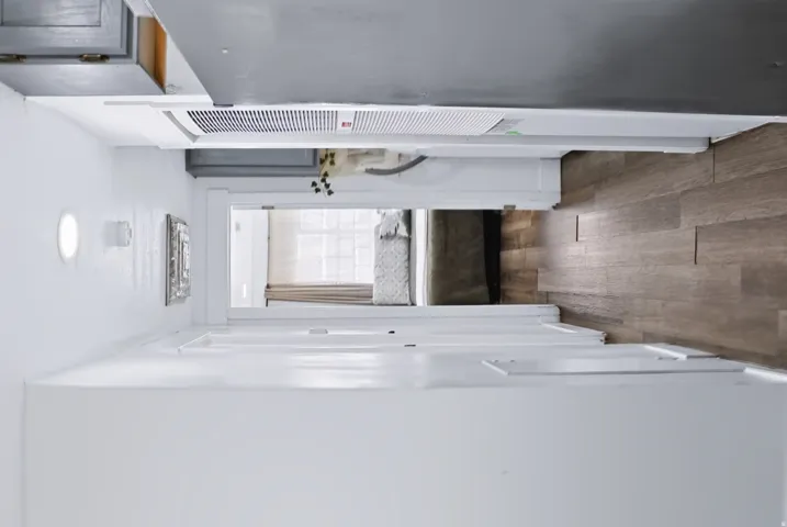 Wood-finish flooring extends from the entryway into the interior space
