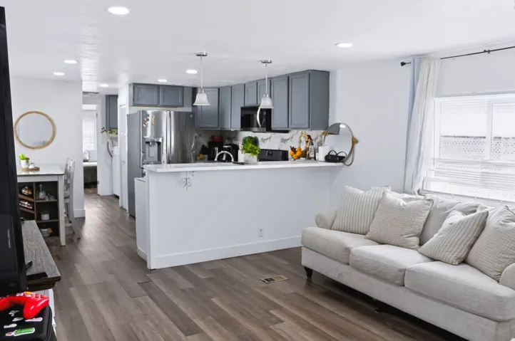 Open-concept living area with wood-finish flooring extending throughout