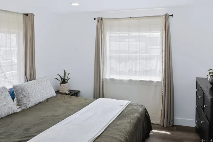 Bedroom featuring recessed lighting, dark wood-finish flooring, and white baseboards