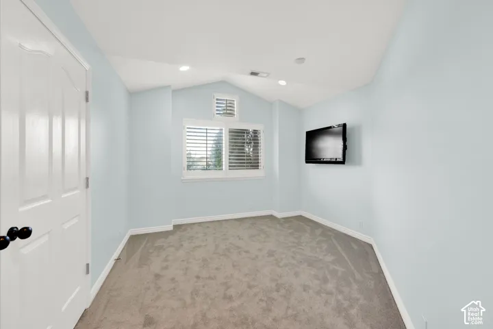 Room featuring light blue walls and gray carpeting