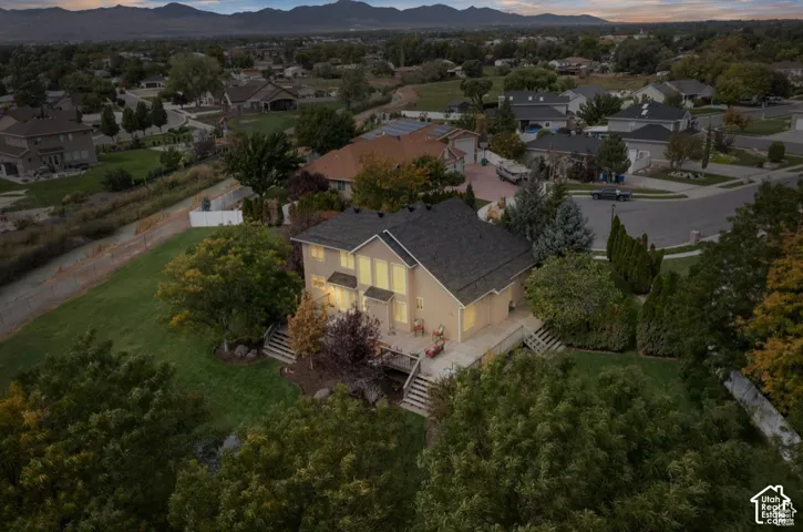 Spacious property featuring a multi-level deck, mature landscaping, and a well-maintained lawn