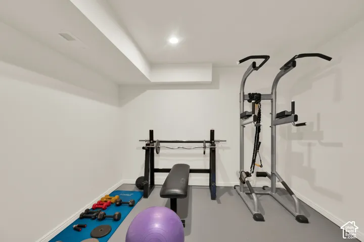 Spacious room with light gray flooring and white walls