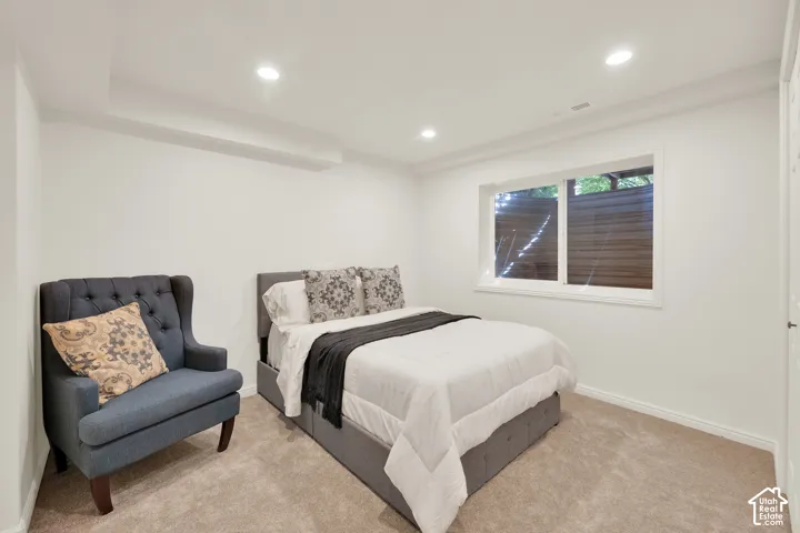 Carpeted room featuring recessed lighting and a window with white trim