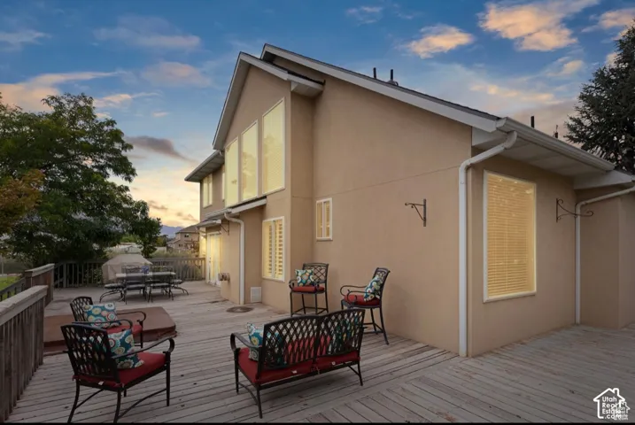 Expansive multi-level wood deck featuring a built-in spa, directly accessible from the home