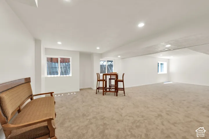Spacious room featuring neutral carpeting and white painted walls
