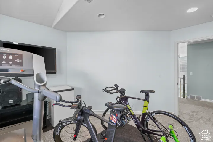 Carpeted room featuring light blue walls and recessed lighting