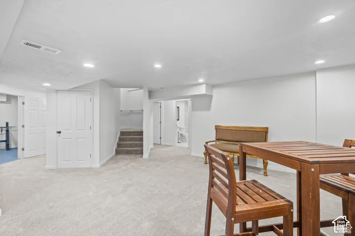 Spacious lower-level area with light-toned carpeting and recessed lighting