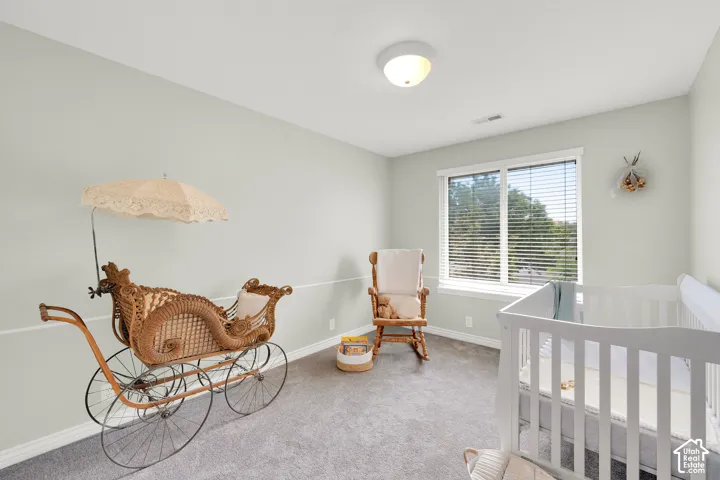 Spacious room with a double window, light gray walls, white trim, and gray carpet flooring