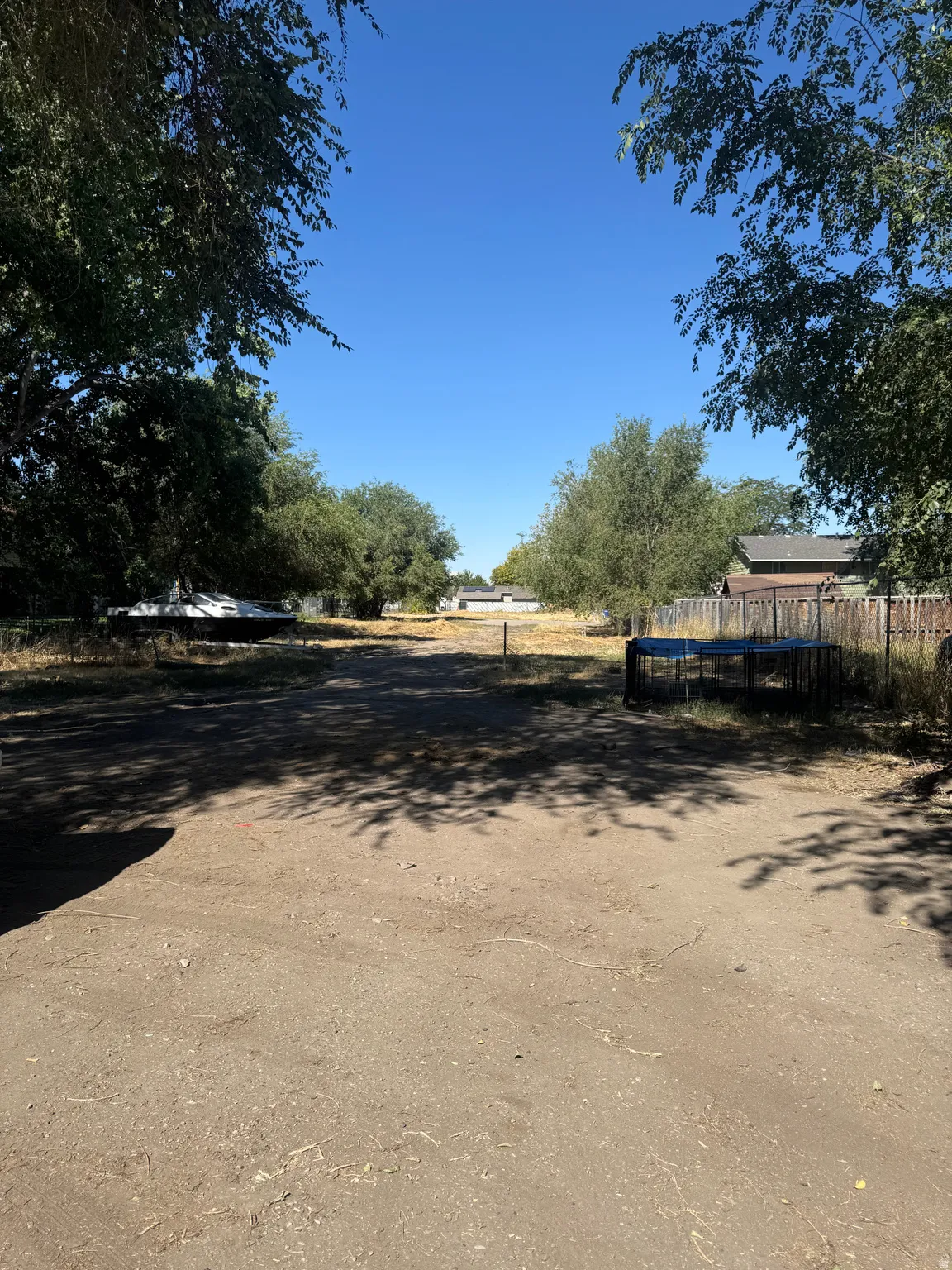 Expansive land parcel featuring existing perimeter fencing and mature trees