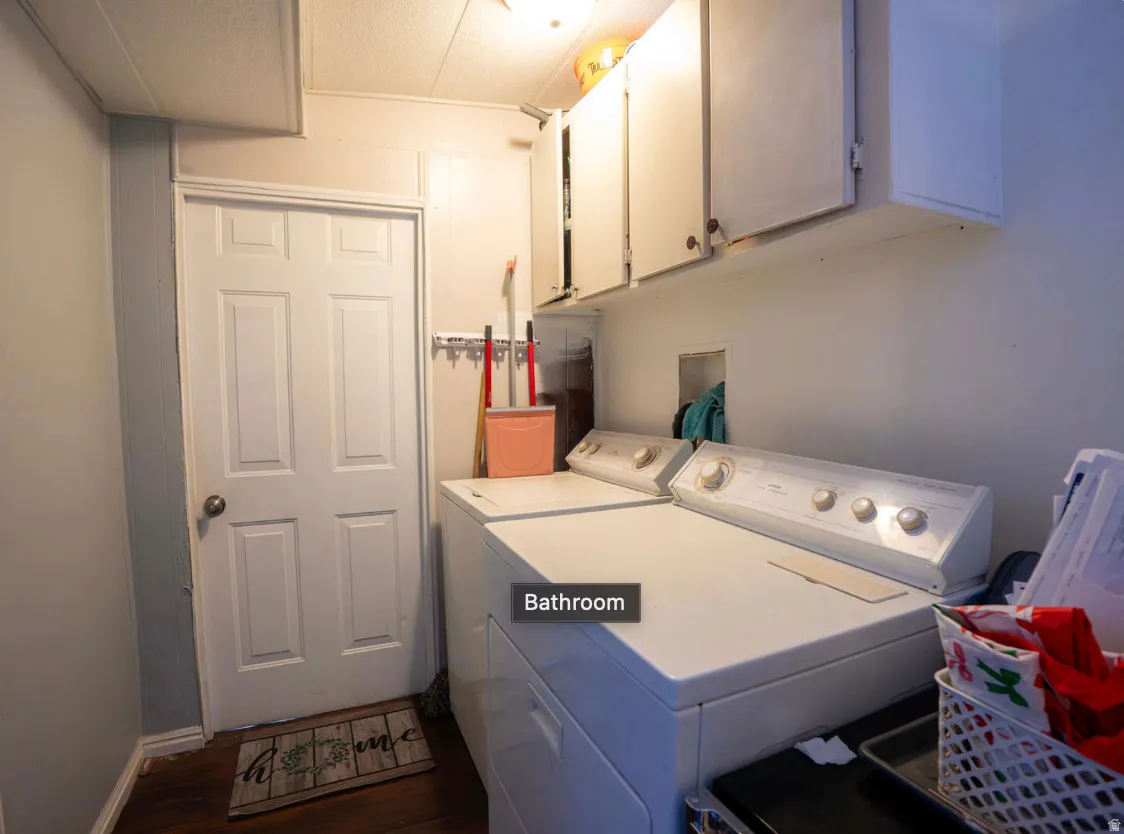 Dedicated laundry area featuring upper cabinetry for storage
