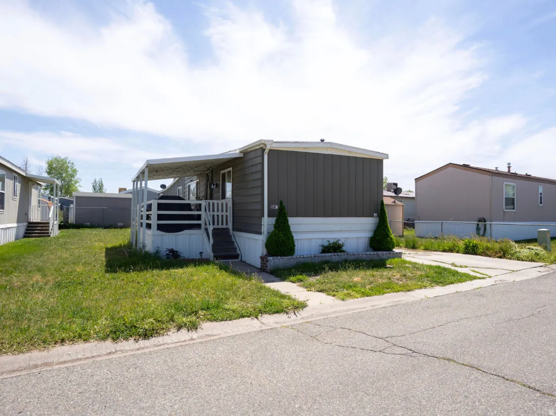 Single-story dwelling with gray panel siding and white trim