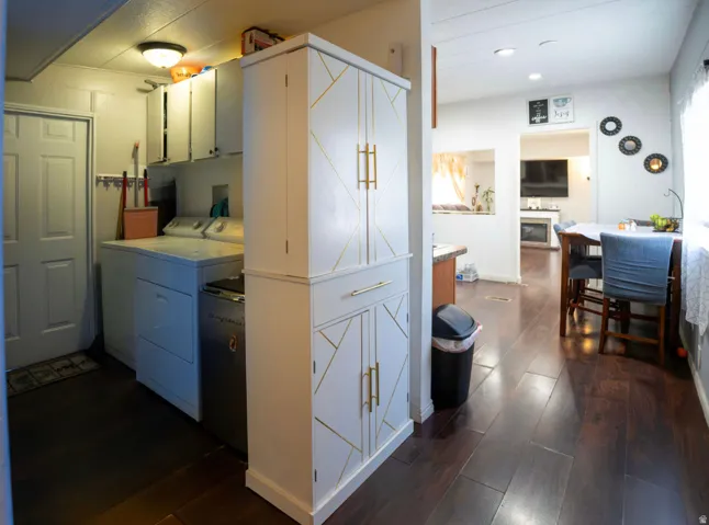 Laundry area with white cabinetry and built-in storage