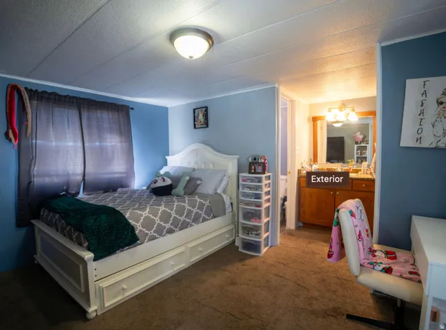 Carpeted bedroom with light blue walls and white trim