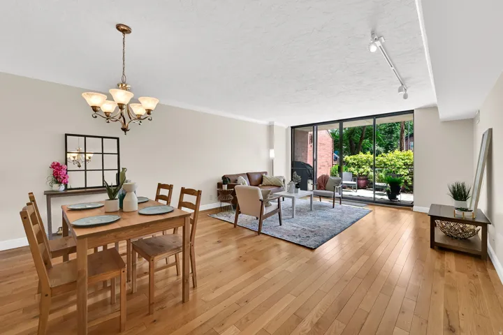 Open concept living area featuring wood-finish flooring