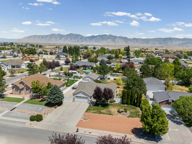 Residential neighborhood featuring multiple single-story homes with varied rooflines and landscaping