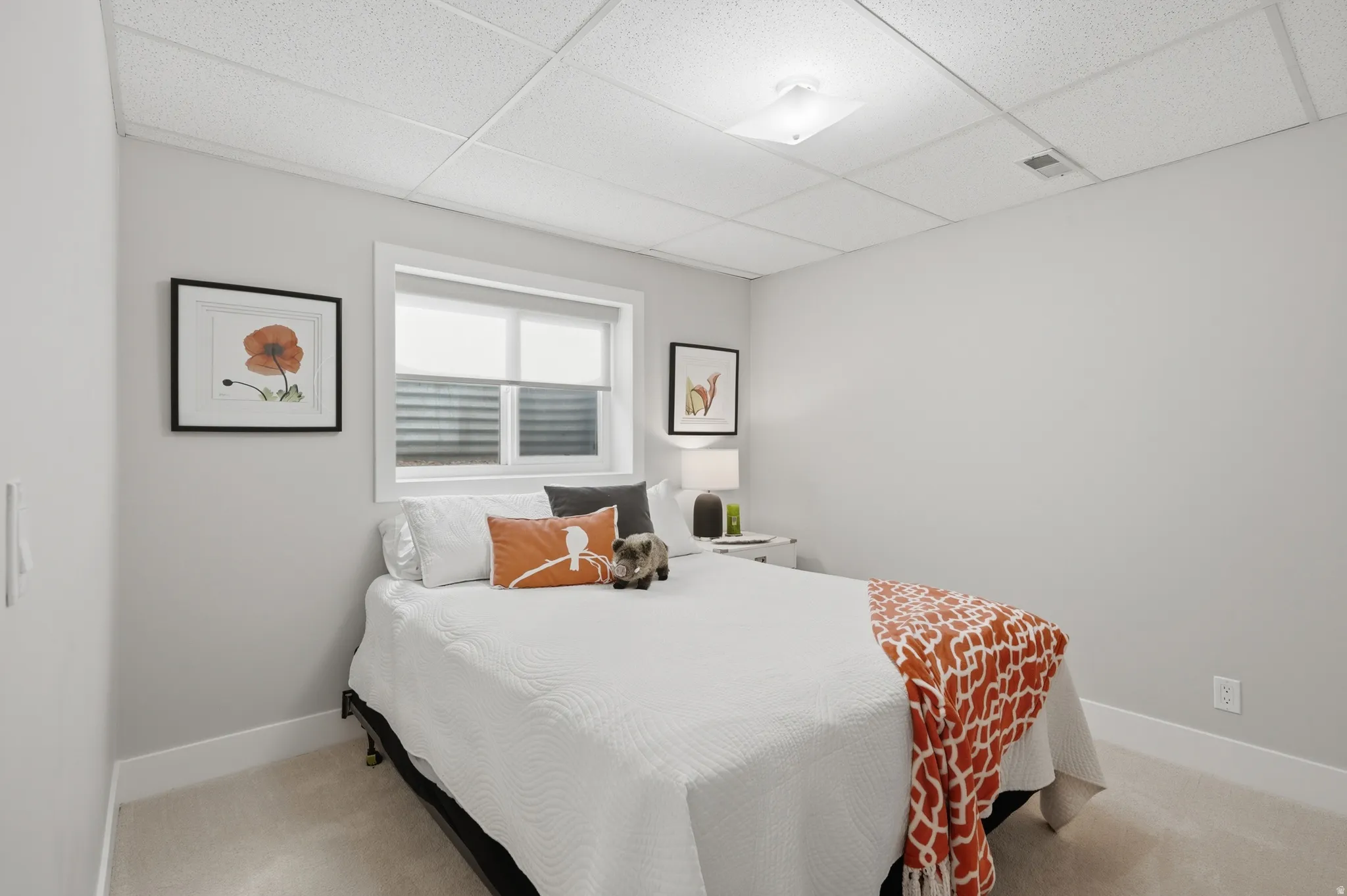 Carpeted room with a drop ceiling and recessed lighting