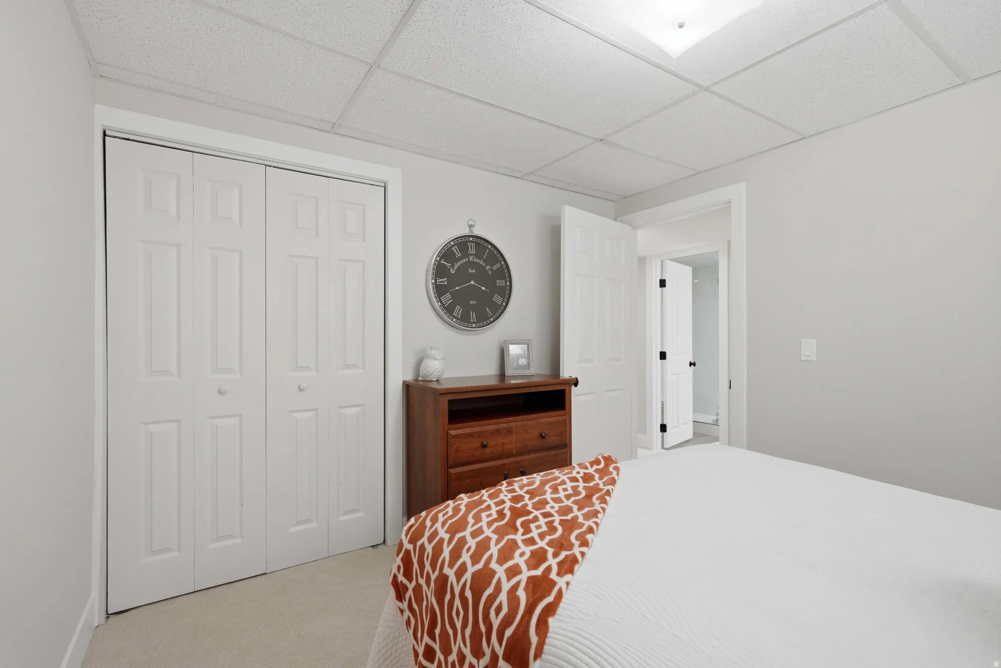 Neutral wall color with white trim and a drop-tile ceiling