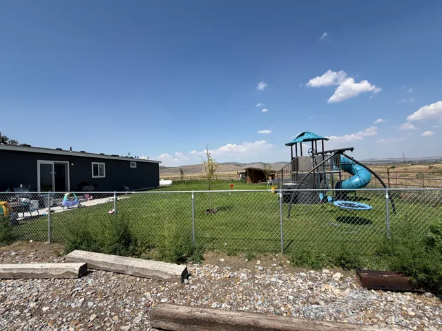 Expansive lawn area enclosed by chain link fencing