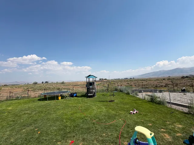 Expansive green lawn with mountain backdrop
