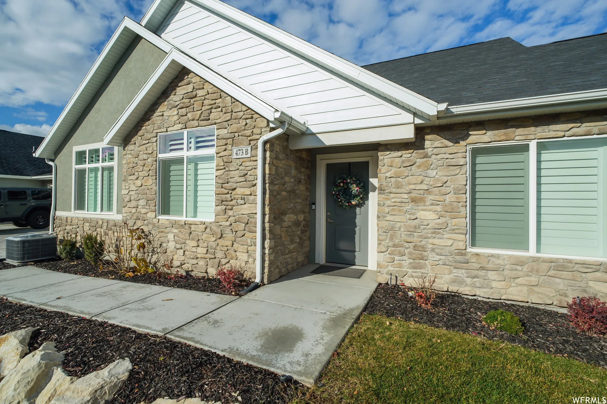 Exterior facade featuring stone veneer and stucco accents