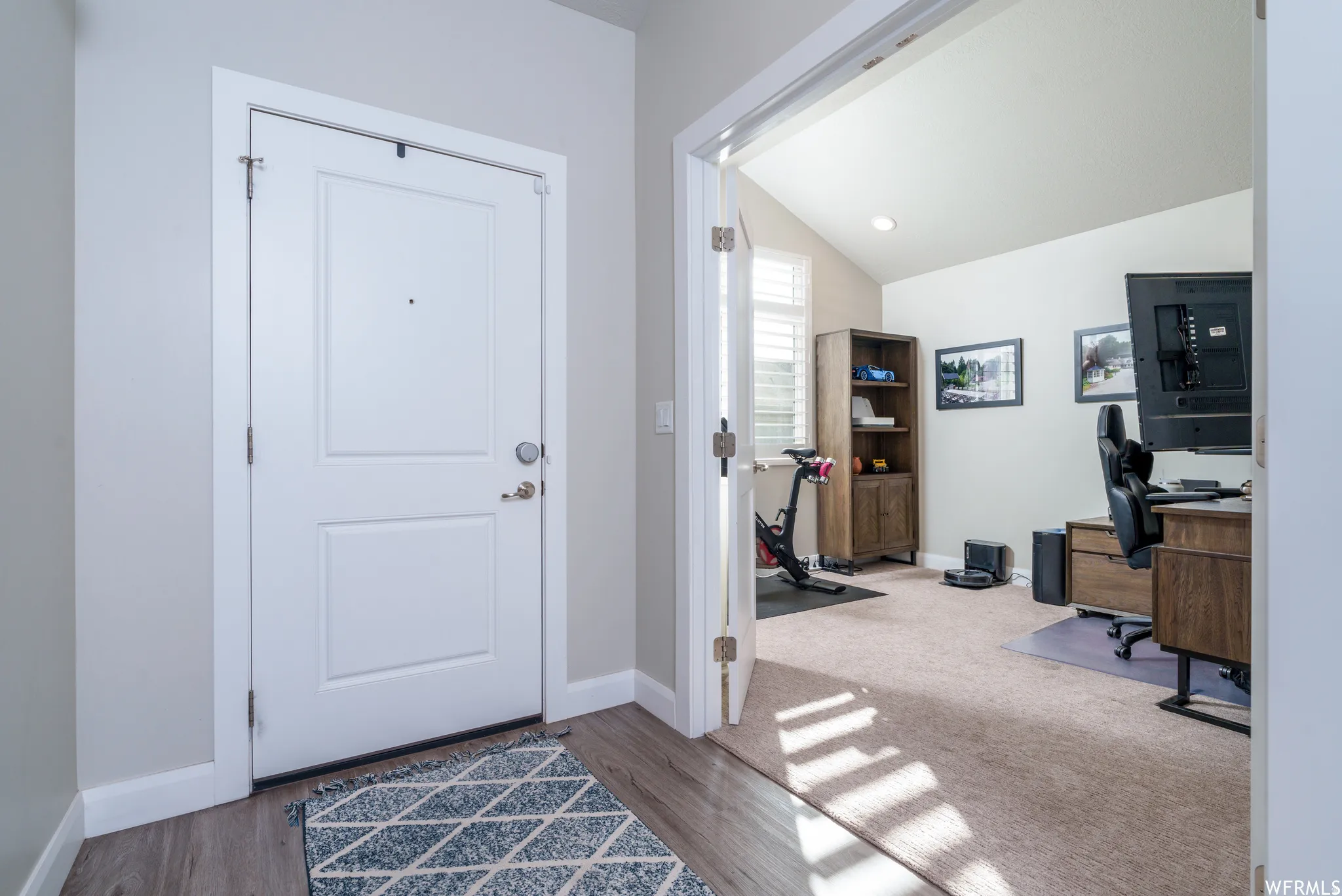 Entryway featuring wood-finish flooring, light gray wall paint, and a two-panel door