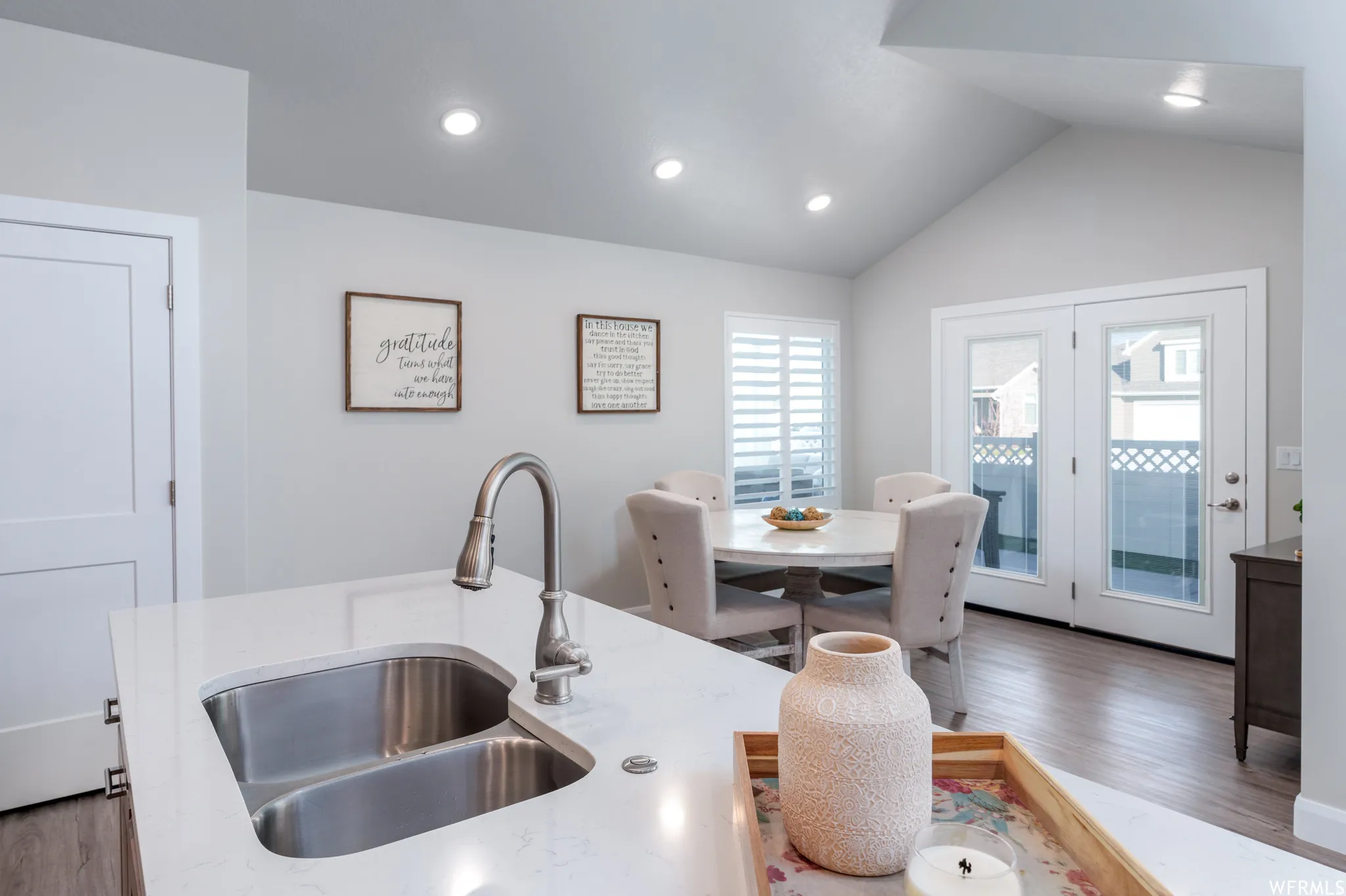 Kitchen island with a double basin stainless steel sink and a gooseneck faucet