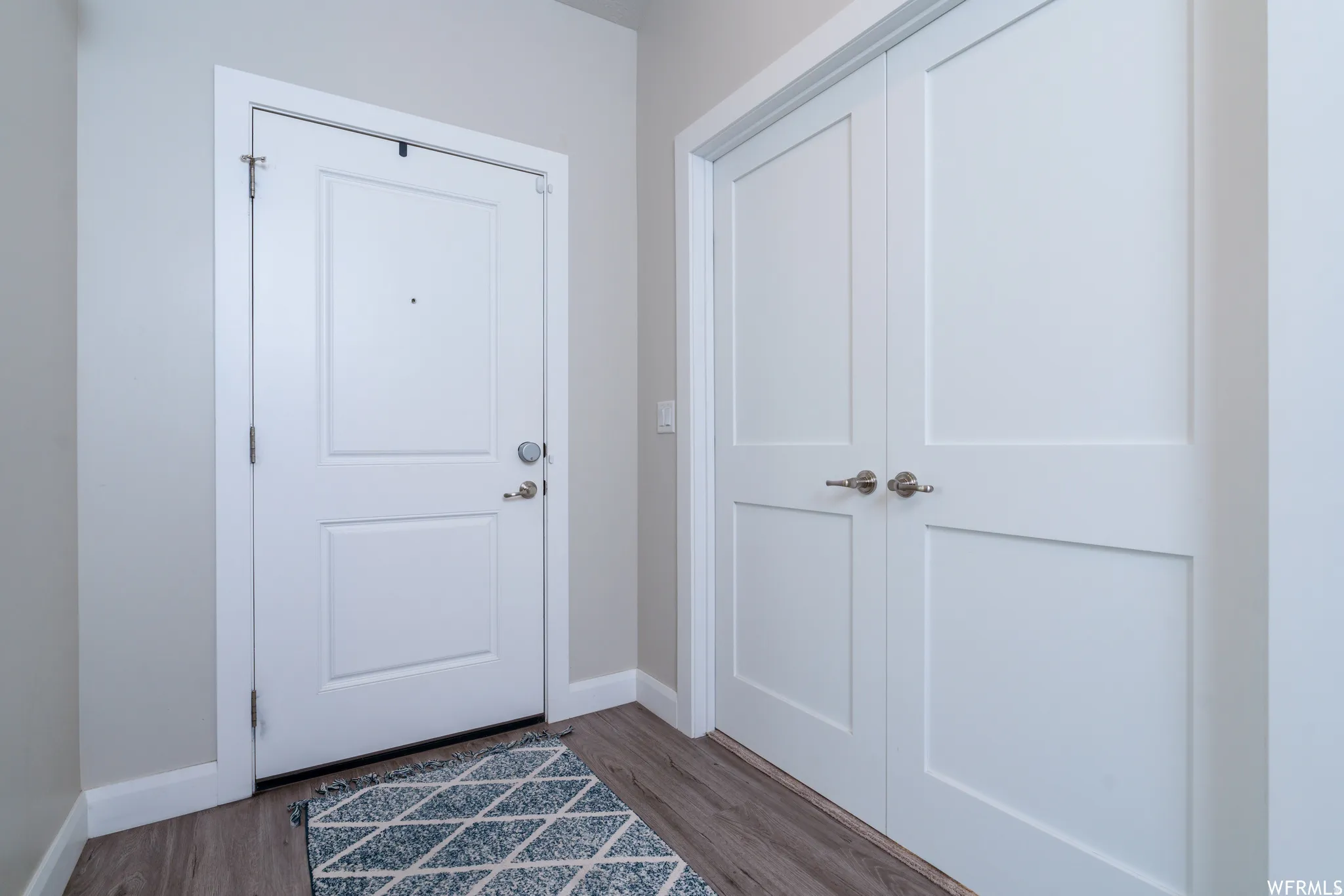 White two-panel main entry door with brushed nickel hardware