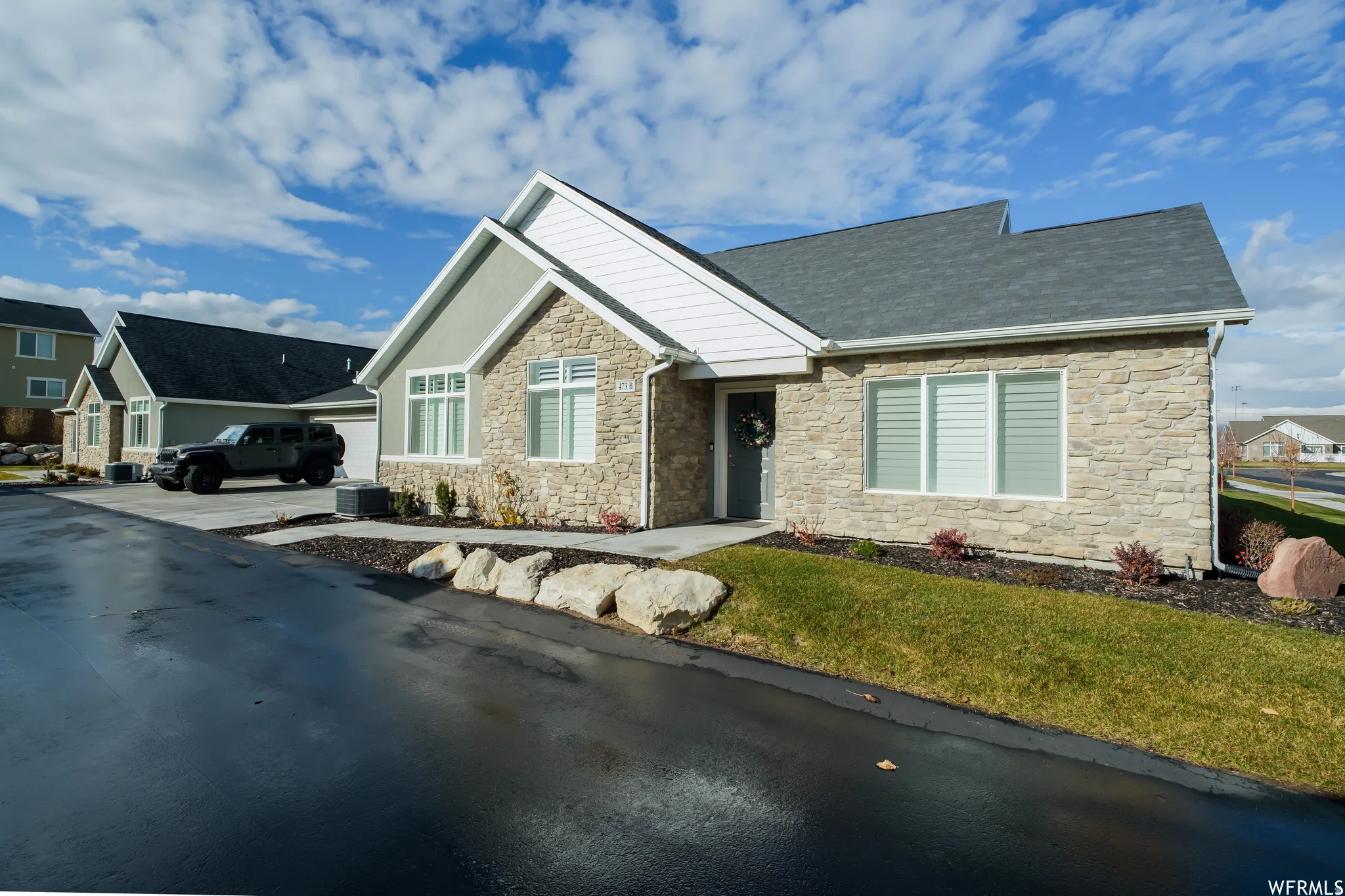 Modern single-story residence with a stone veneer and stucco exterior