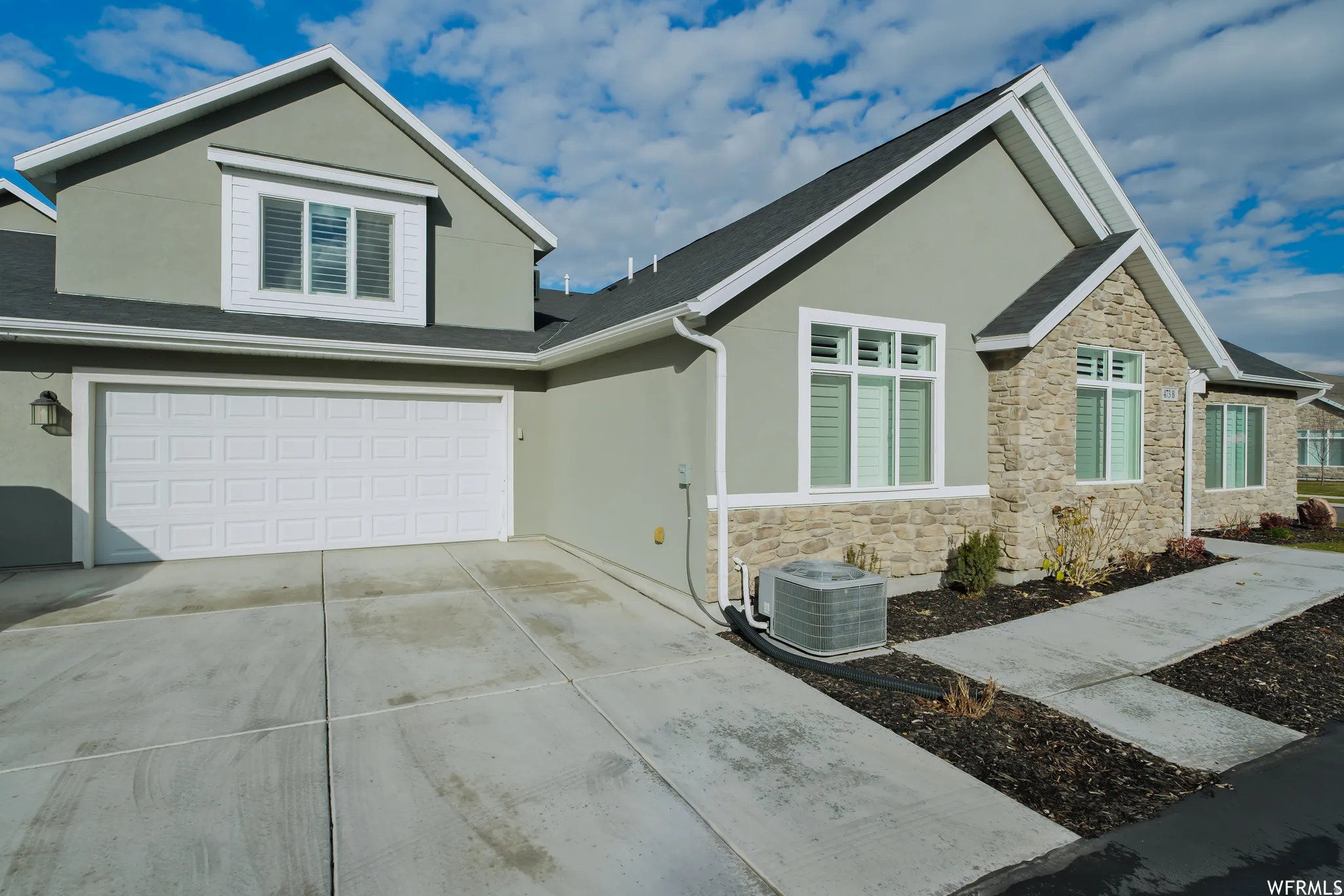 Contemporary exterior featuring a stone and stucco facade