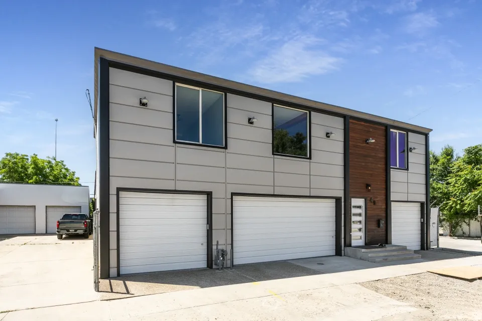 Modern multi-unit property featuring a contemporary facade with horizontal siding and wood panel accents