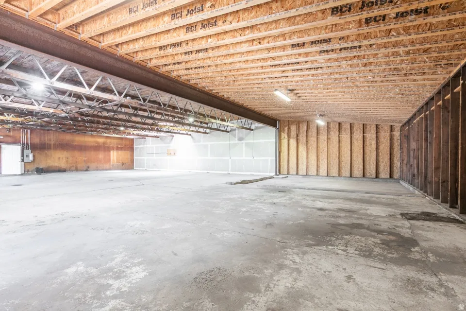 Expansive concrete flooring with exposed ceiling joists and structural beams