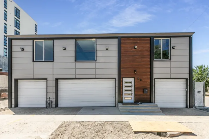 Modern facade with mixed-material finishes, including horizontal paneling and wood-look siding