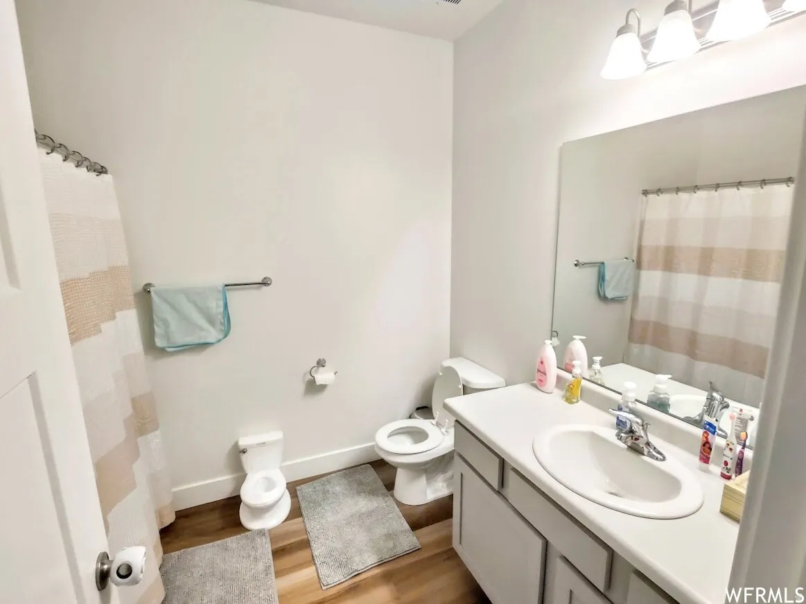 Bathroom with a single vanity, undermount sink, and light-colored countertop