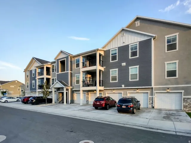 Contemporary multi-story building featuring a blend of gray siding and stucco exteriors