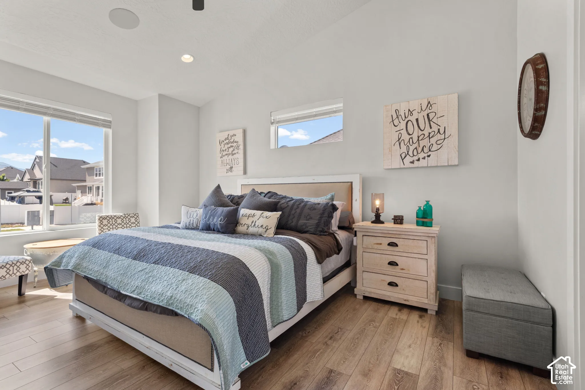 Bedroom featuring wood-finish flooring, large windows, and a vaulted ceiling with recessed lighting