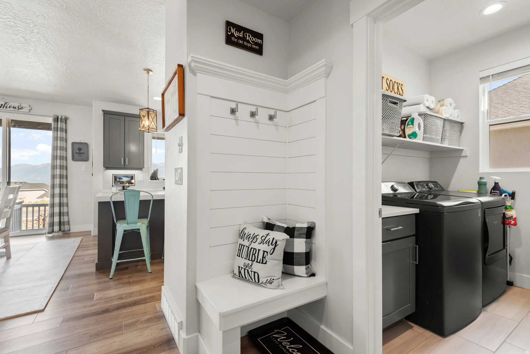 Built-in mudroom bench with shiplap-style wall paneling and coat hooks